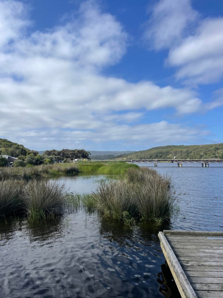 Aire River with a small portion of the dock, reeds and then a beautiful blue sky with wispy white clouds.