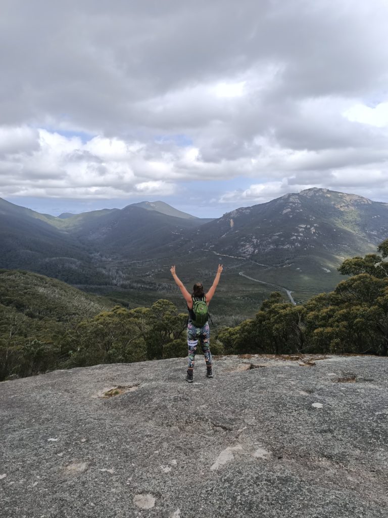 Mount Bishop Summit - large smooth boulder looking out inland. You can see the Wilsons Prom Rd and cloudy skys.